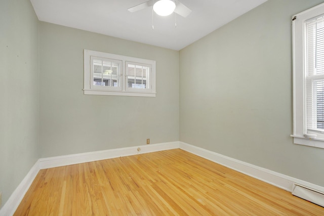 5421 30th Ave S, Minneapolis, MN 55417 - unfurnished room featuring hardwood / wood-style floors, ceiling fan, and a baseboard heating unit