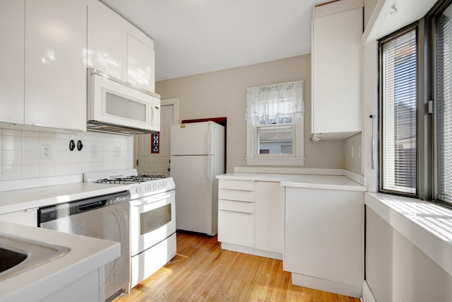 5421 30th Ave S, Minneapolis, MN 55417 - kitchen with backsplash, white appliances, a wealth of natural light, and white cabinets