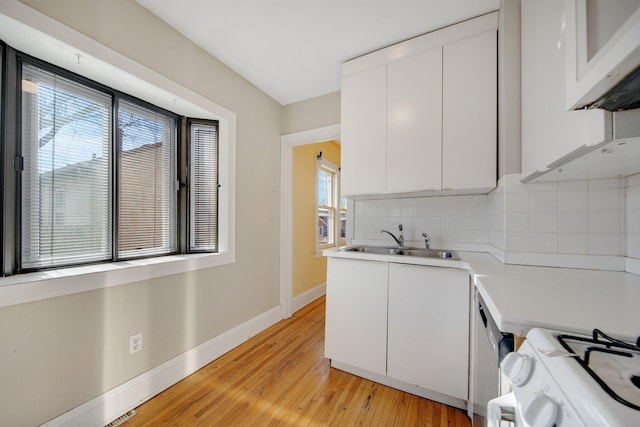 5421 30th Ave S, Minneapolis, MN 55417 - kitchen with white cabinetry, white range with gas cooktop, sink, and tasteful backsplash