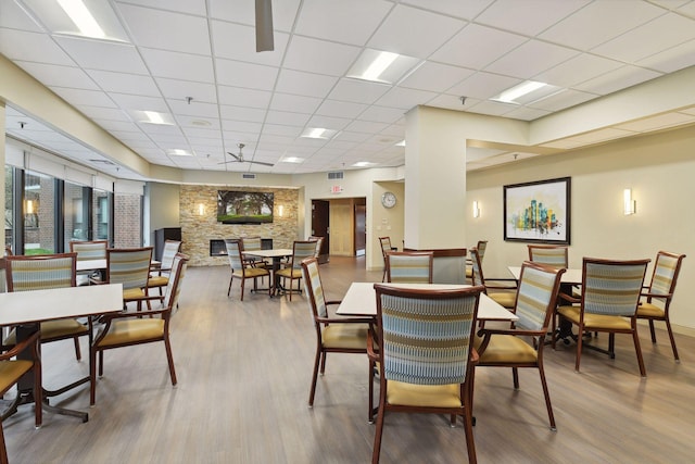 dining space featuring a paneled ceiling and hardwood / wood-style floors