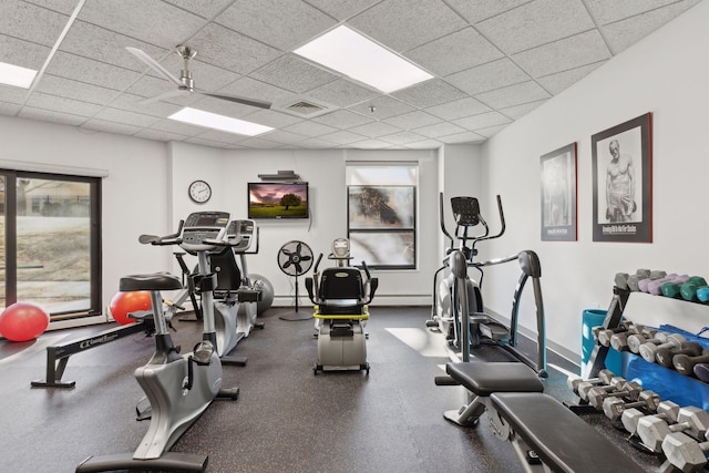 exercise room with a paneled ceiling