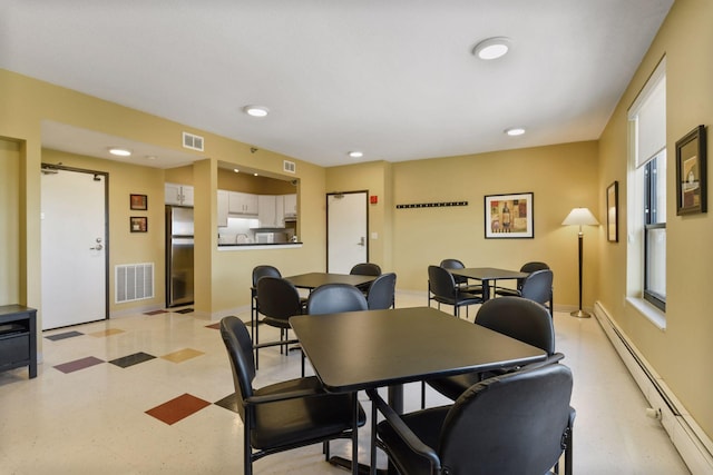 dining area featuring a baseboard heating unit