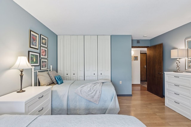 6615 Lake Shore Dr S Unit 403, Richfield, MN 55423 - bedroom featuring light wood-style floors and a closet