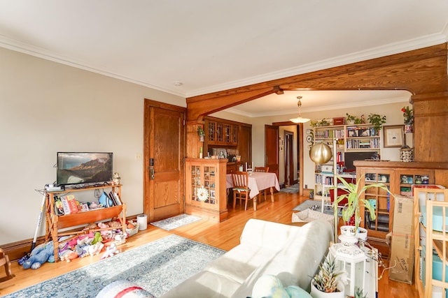 living room with light hardwood / wood-style flooring and ornamental molding