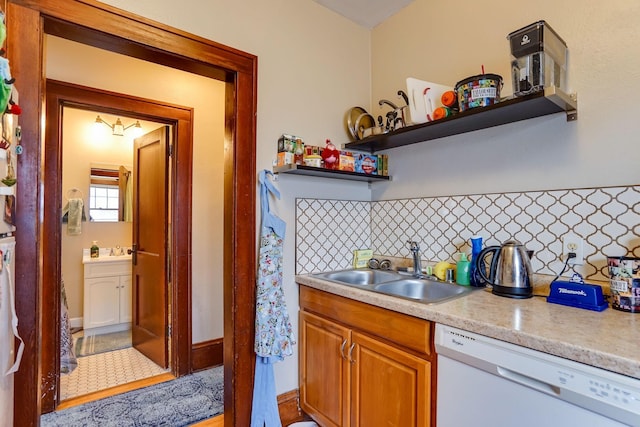 kitchen with white dishwasher, sink, and decorative backsplash