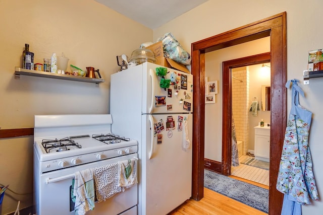 kitchen with white appliances and light hardwood / wood-style flooring