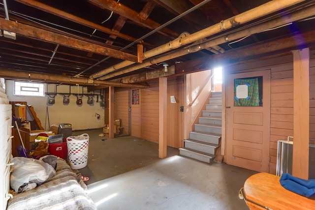 basement featuring wood walls