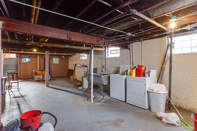 basement with separate washer and dryer and sink