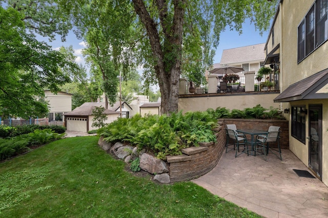 view of yard featuring outdoor dining space, a patio area, and fence