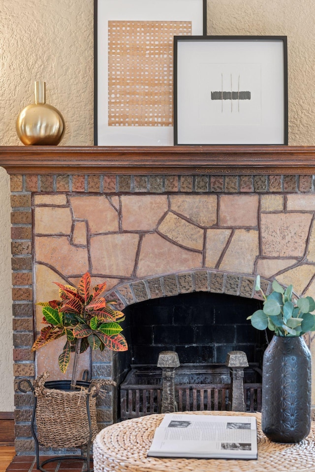 details with a fireplace and a textured wall