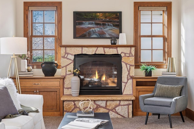 carpeted living area featuring a fireplace