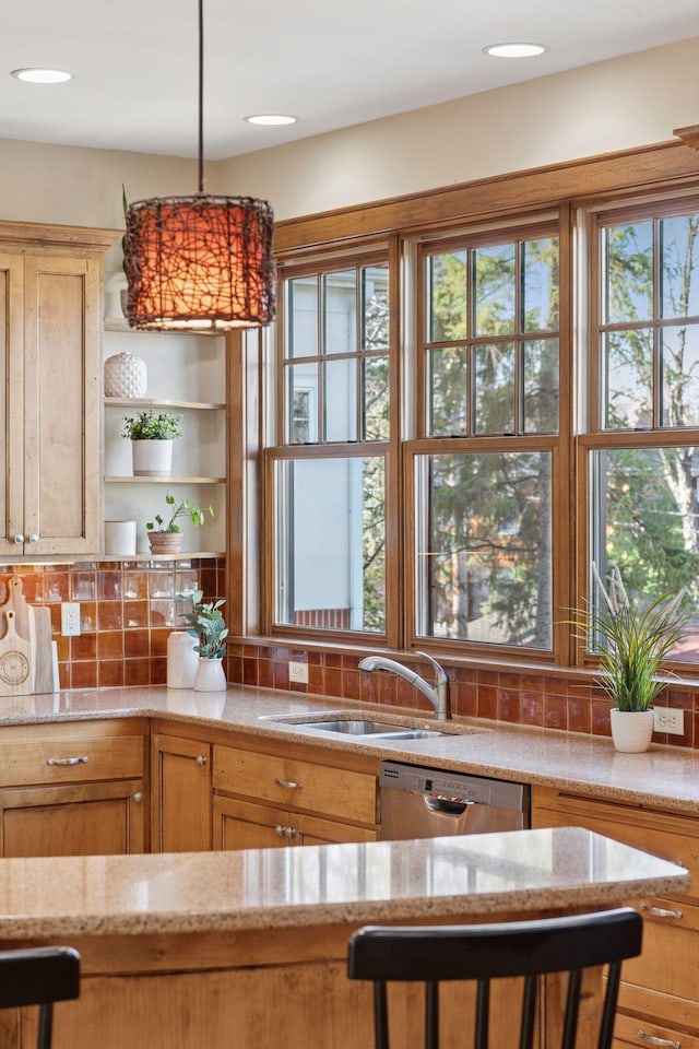 kitchen featuring backsplash, open shelves, light stone countertops, dishwasher, and a sink