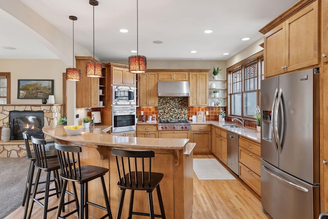 kitchen featuring open shelves, under cabinet range hood, tasteful backsplash, stainless steel appliances, and a peninsula