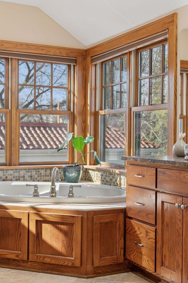 bathroom featuring lofted ceiling