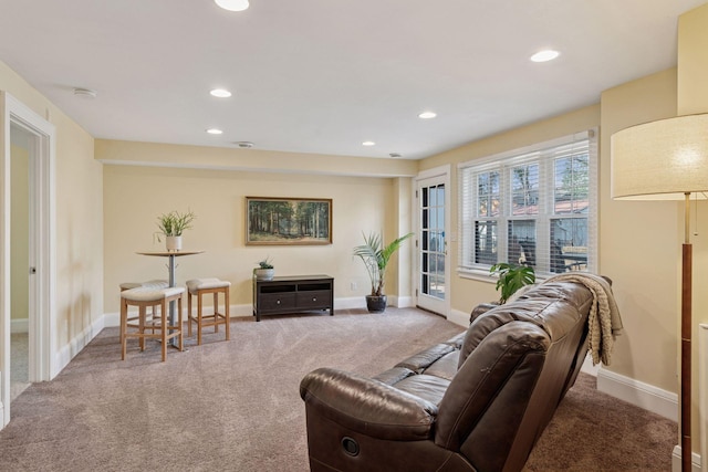 carpeted living area with recessed lighting and baseboards