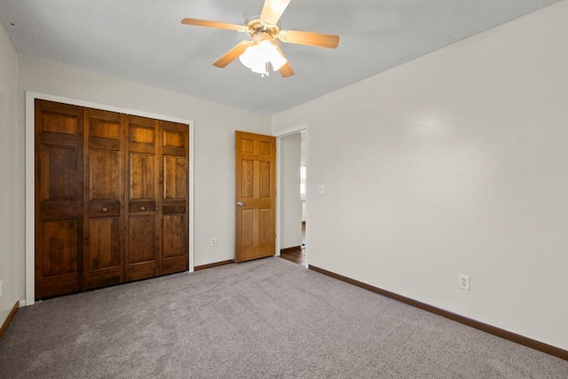 unfurnished bedroom featuring ceiling fan, a closet, and carpet