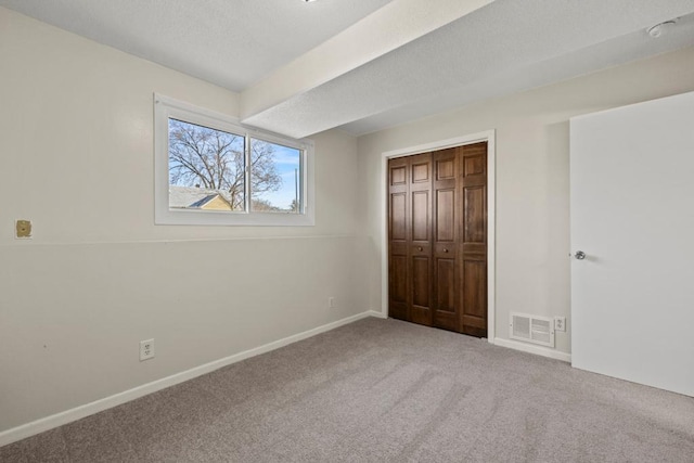 unfurnished bedroom with carpet flooring and a closet