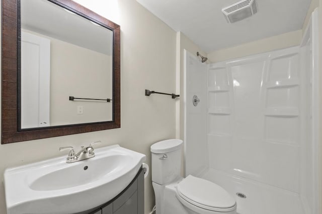 bathroom with sink, toilet, and walk in shower