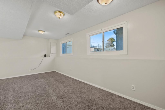 carpeted spare room featuring a textured ceiling