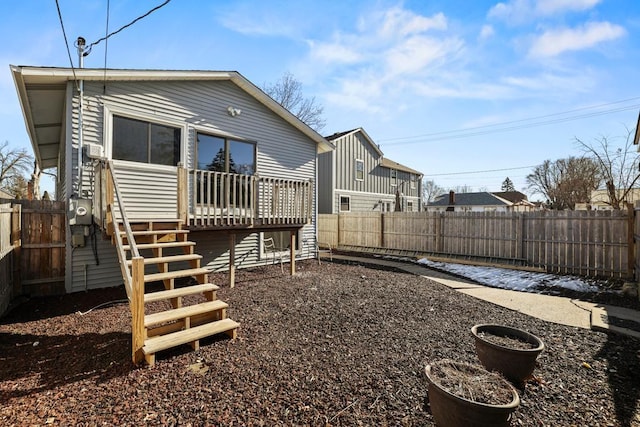 rear view of house featuring a deck