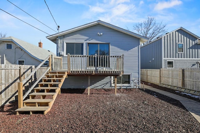 back of house featuring a wooden deck