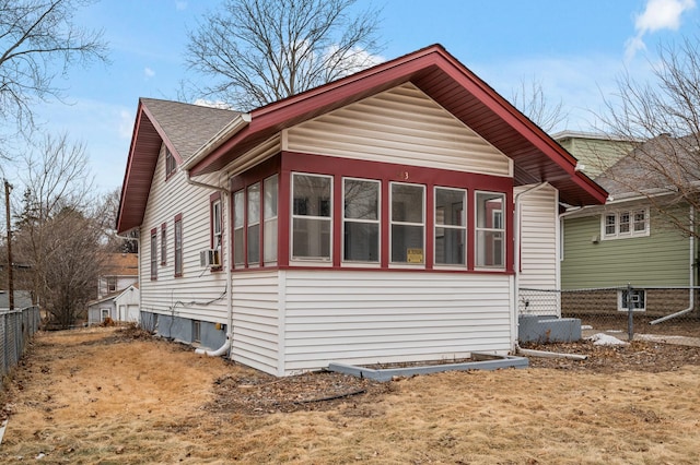 3431 Irving Ave N, Minneapolis, MN 55412 - view of side of home with fence, a shingled roof, and cooling unit