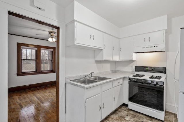 3431 Irving Ave N, Minneapolis, MN 55412 - kitchen featuring white appliances, under cabinet range hood, a ceiling fan, light countertops, and white cabinets