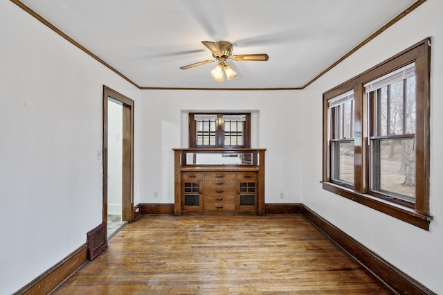 3431 Irving Ave N, Minneapolis, MN 55412 - spare room with crown molding, wood finished floors, and ceiling fan