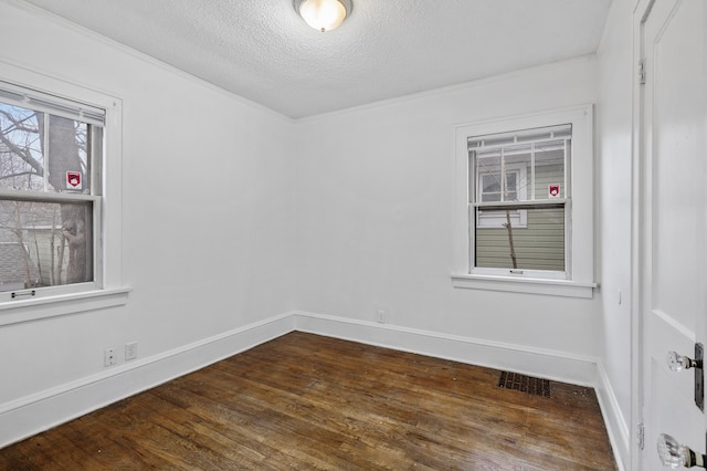3431 Irving Ave N, Minneapolis, MN 55412 - unfurnished room with dark wood-style flooring, a textured ceiling, and ornamental molding