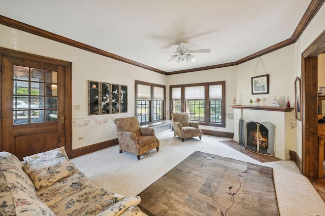 carpeted living room with crown molding, ceiling fan, and a textured ceiling