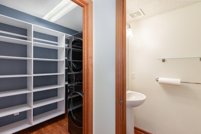 bathroom featuring visible vents, a textured ceiling, and wood finished floors