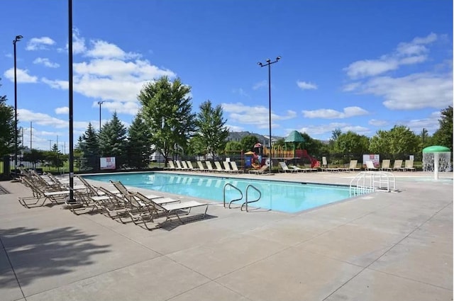 community pool featuring a patio area and fence