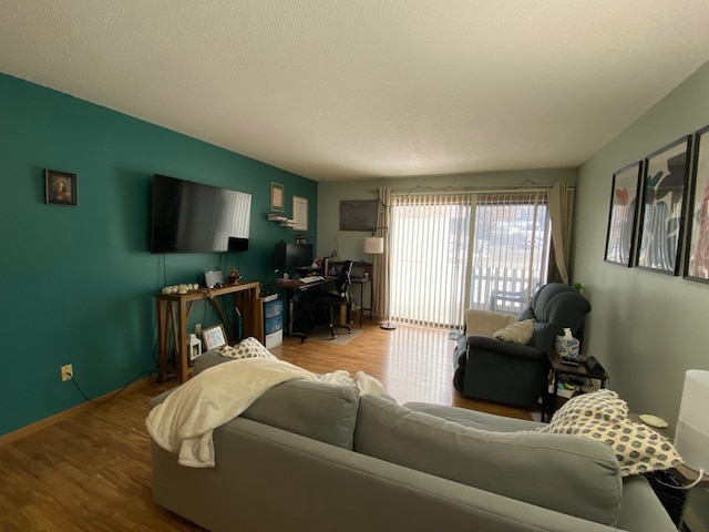 living room featuring hardwood / wood-style flooring and a textured ceiling