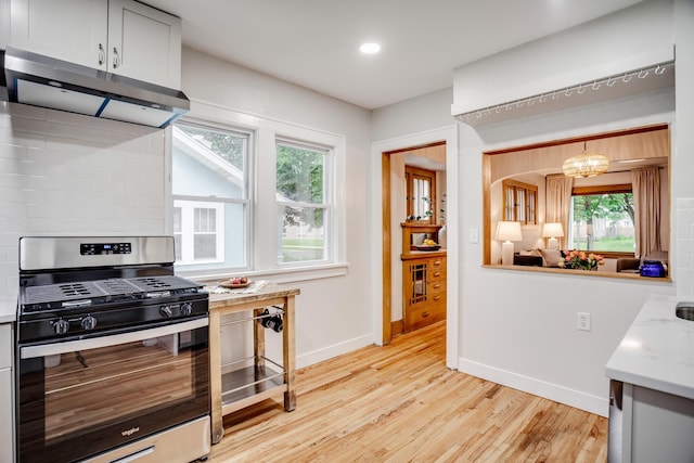 4415 Snelling Ave, Minneapolis, MN 55406 - kitchen with stainless steel gas stove, range hood, healthy amount of natural light, light wood-type flooring, and recessed lighting