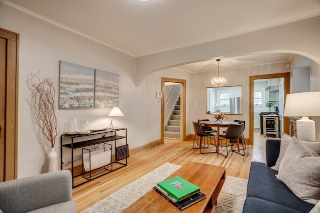 4415 Snelling Ave, Minneapolis, MN 55406 - living room with arched walkways, stairway, ornamental molding, and wood finished floors