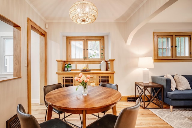 4415 Snelling Ave, Minneapolis, MN 55406 - dining space featuring wood finished floors, a chandelier, and ornamental molding