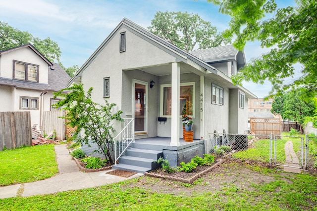 4415 Snelling Ave, Minneapolis, MN 55406 - bungalow-style home with stucco siding and a gate
