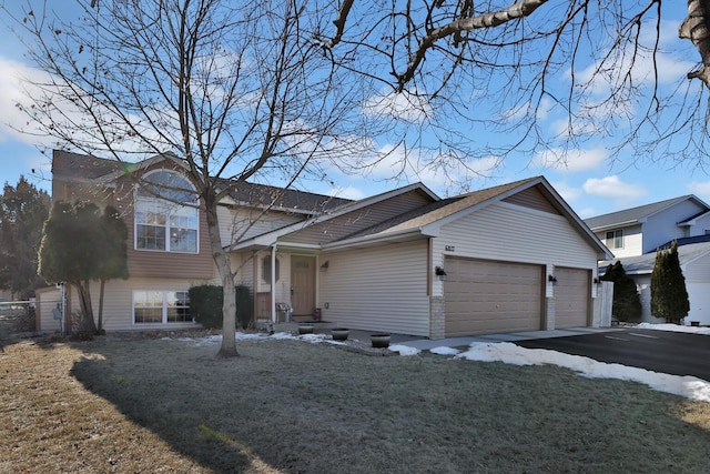 view of front of home with a garage and a front yard