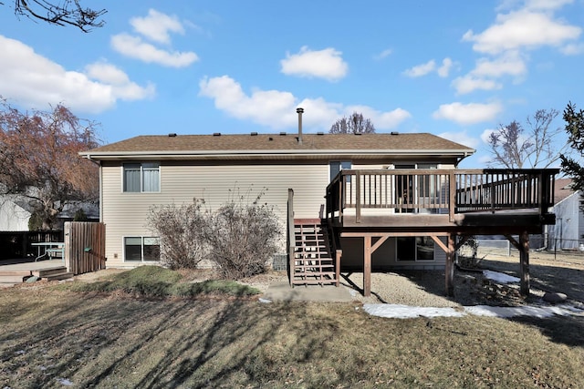 rear view of house with a yard and a deck