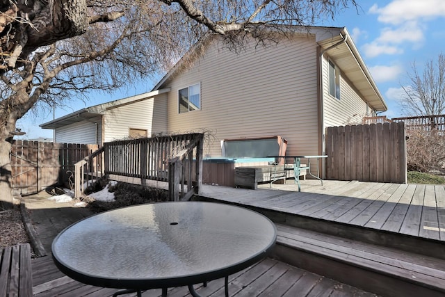 wooden deck with a hot tub