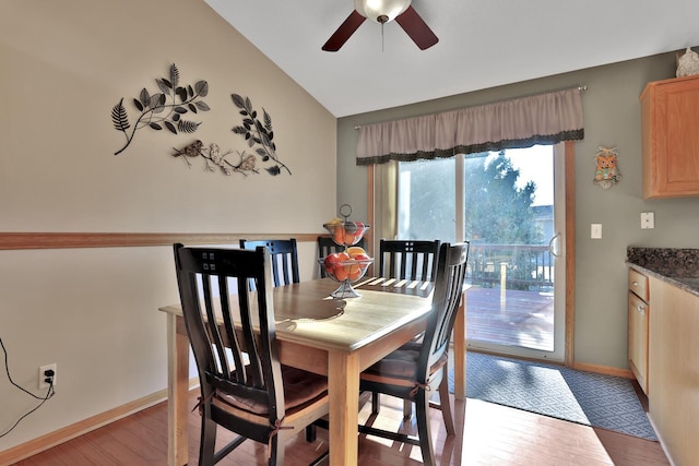 dining area featuring vaulted ceiling, ceiling fan, and light hardwood / wood-style flooring