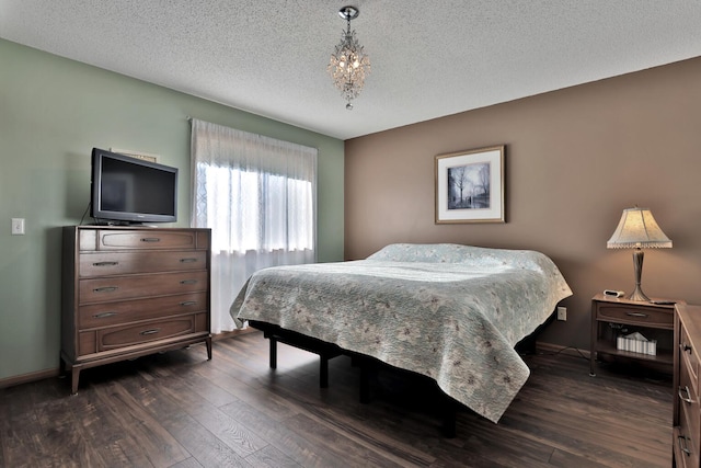 bedroom with dark hardwood / wood-style flooring and a textured ceiling