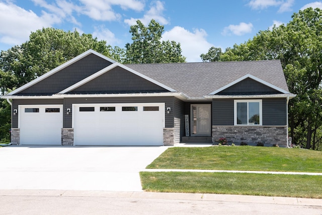 craftsman inspired home with a garage and a front yard