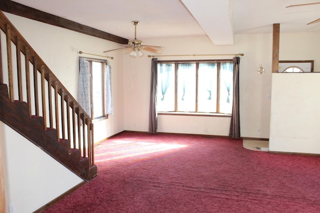 unfurnished living room with beamed ceiling, carpet flooring, and ceiling fan