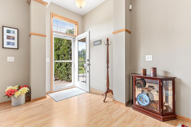 foyer with a high ceiling and light wood-type flooring