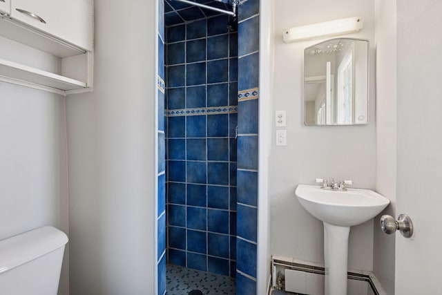 full bathroom featuring a baseboard radiator, toilet, and a shower stall