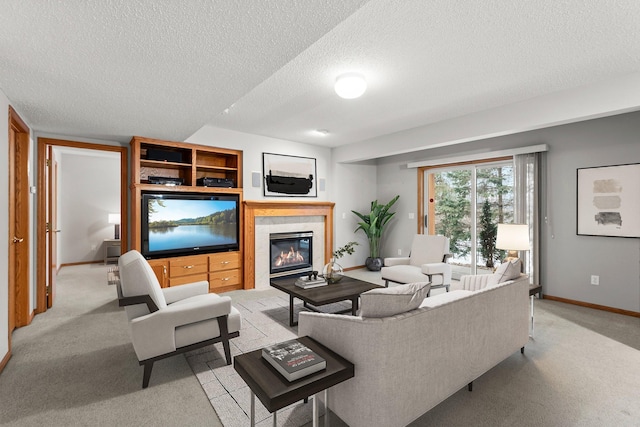 living room featuring light carpet, a fireplace, and a textured ceiling