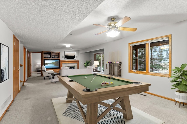 recreation room with ceiling fan, billiards, light carpet, and a textured ceiling