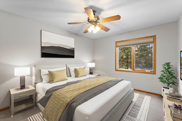 bedroom featuring ceiling fan, carpet floors, and a textured ceiling