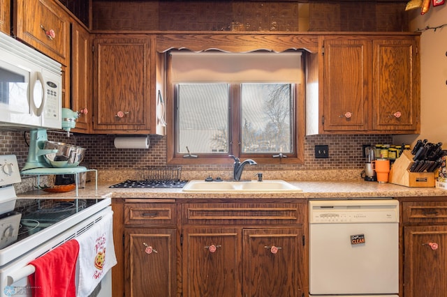 kitchen with sink, backsplash, and white appliances